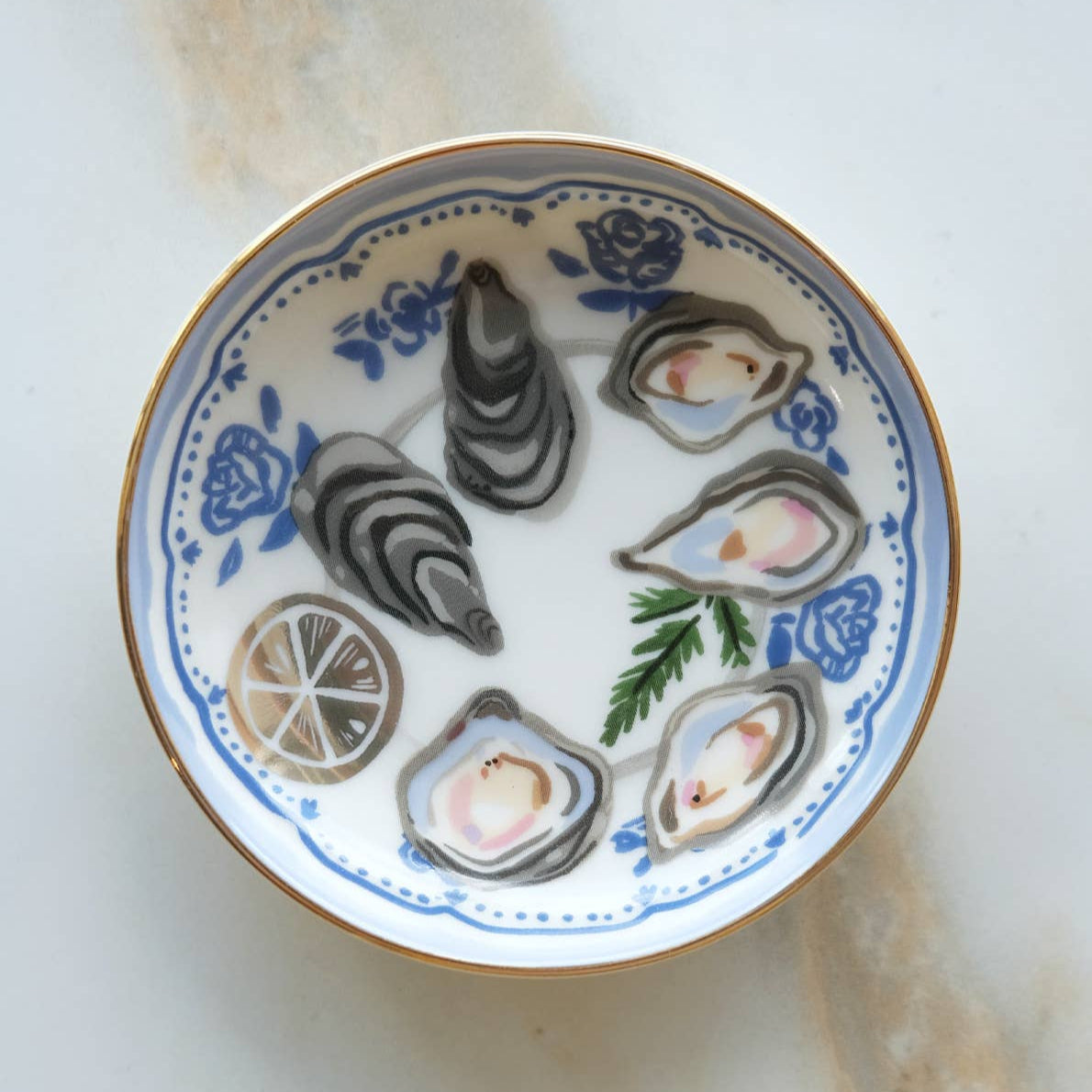 Decorative plate with oyster shells and lemon slices on a white background