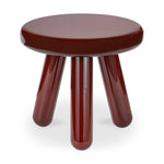 Round brown stool with four legs on a white background