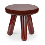 Round brown stool with four legs on a white background