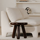Modern white sofa with a wooden side table in a minimalistic living room.