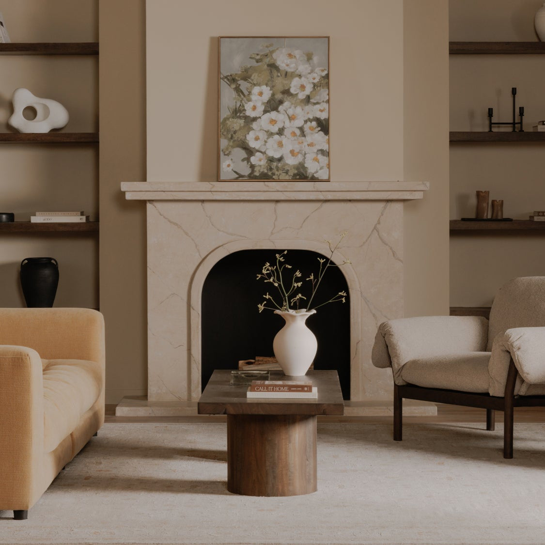 Living room with beige sofa, wooden coffee table, and fireplace.