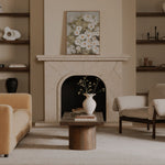 Living room with beige sofa, wooden coffee table, and fireplace.