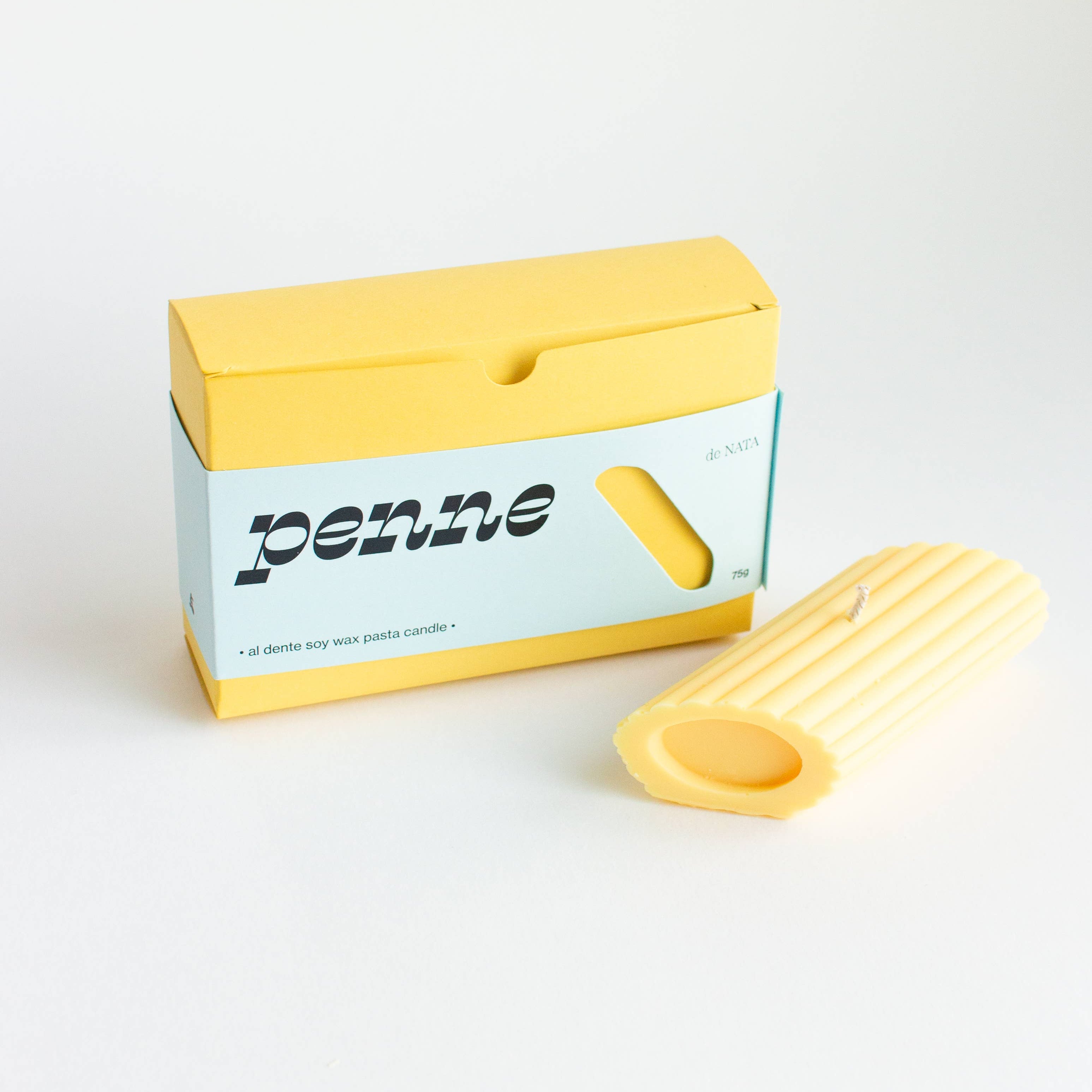 Yellow penne pasta packaging with a single penne on a white background