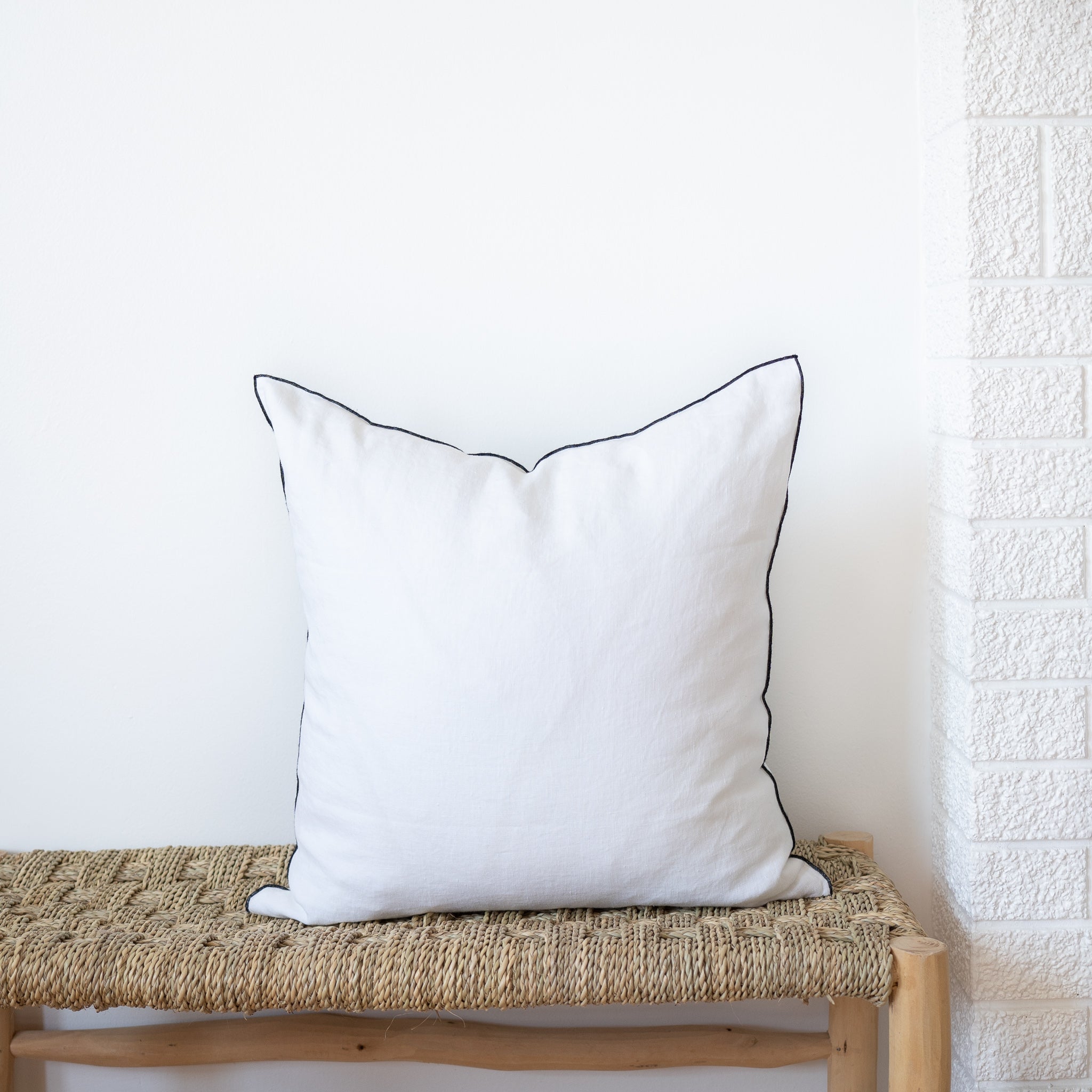 white square linen pillow with black edges