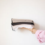 natural beige, charcoal, blush, and white linen napkin with black edge