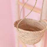 small woven straw hanging planter