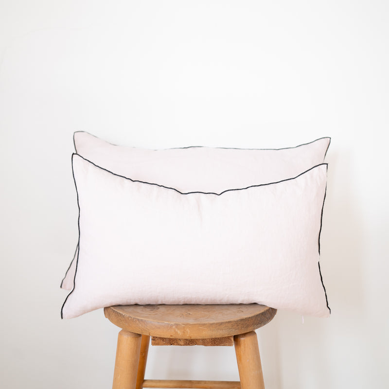 2 blush linen lumbar pillow with black edge