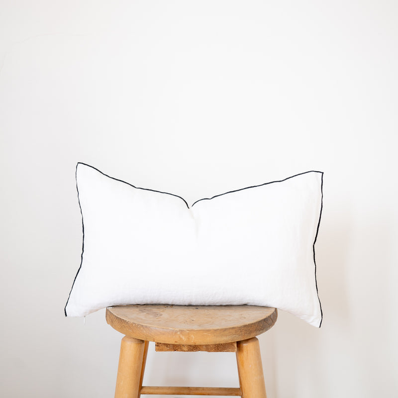white linen lumbar pillow with black edge