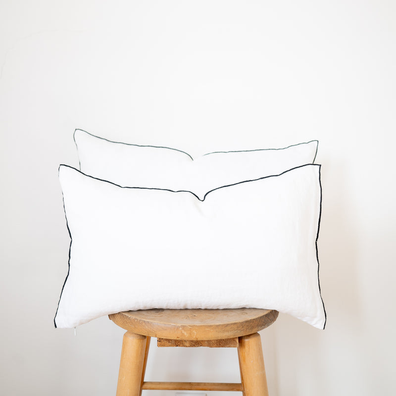 pair of white linen lumbar pillow with black edge