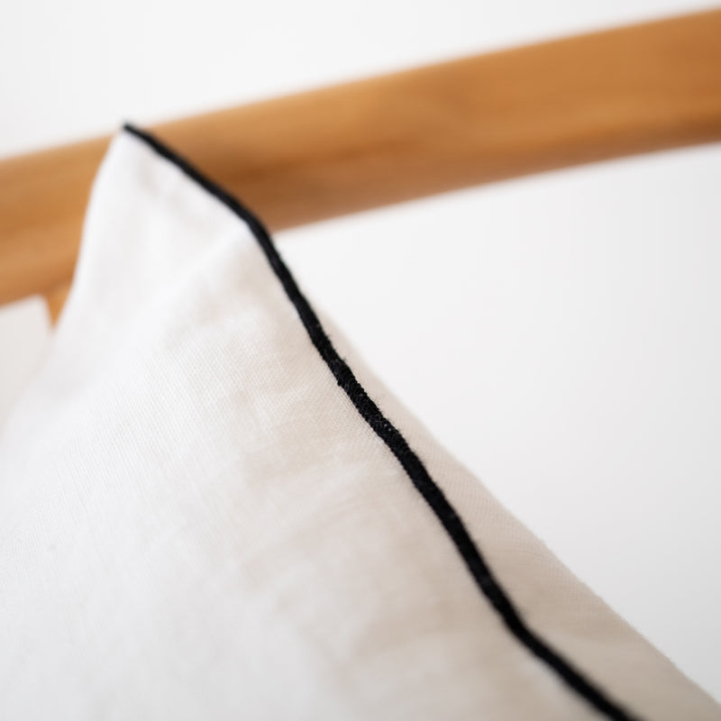 white linen lumbar pillow with black edge