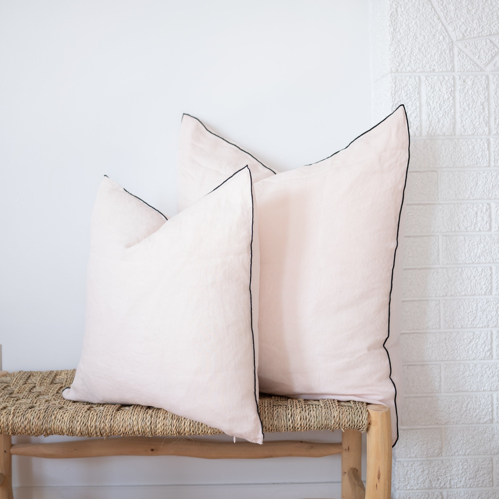 2 sizes of blush square linen pillow with black edges