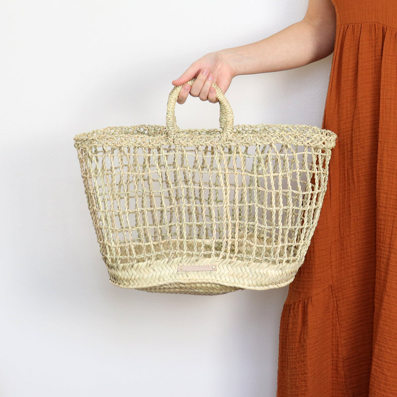 open weave handwoven straw market basket with straps