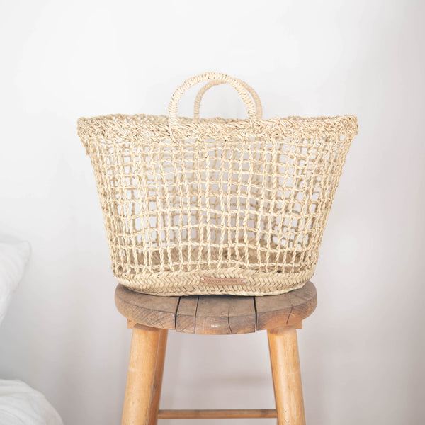 open weave handwoven straw market basket with straps