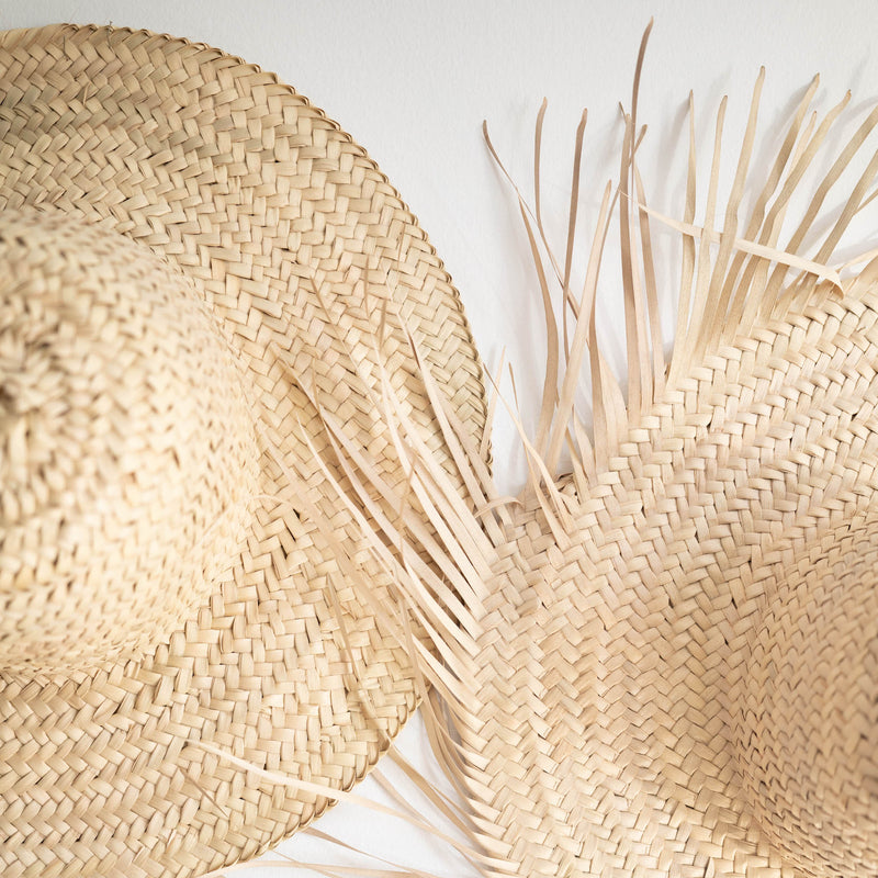 large fringed decorative handwoven straw hat