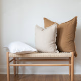 white linen fringed lumbar pillow and square fringed camel and natural pillow