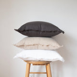 charcoal, natural, and white square fringed linen pillow