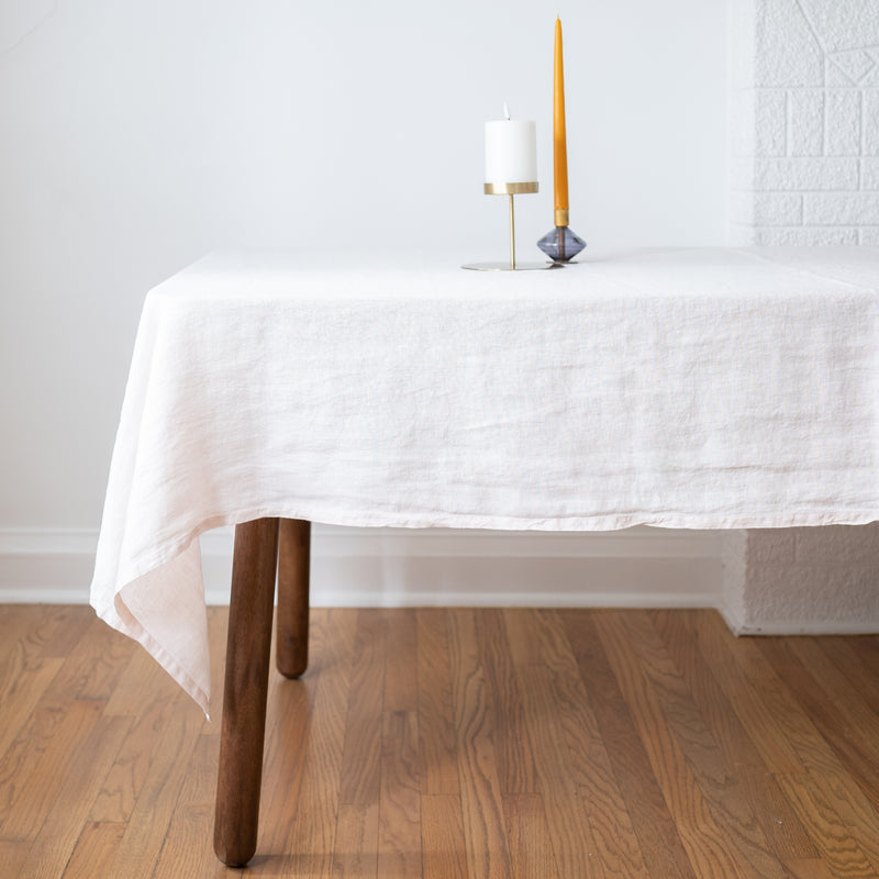 White linen tablecloth on wood dining table